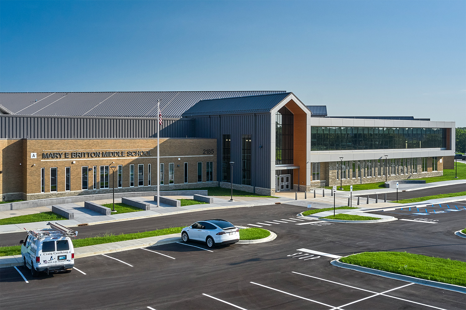 Outside of a middle school and parking lot.